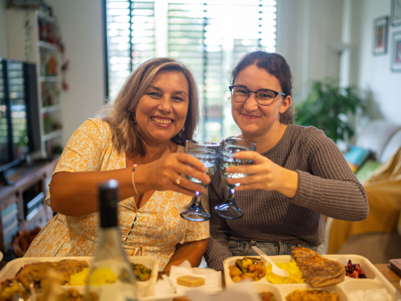Two women wrap up their Mother's Day cooking class with the dishes they made